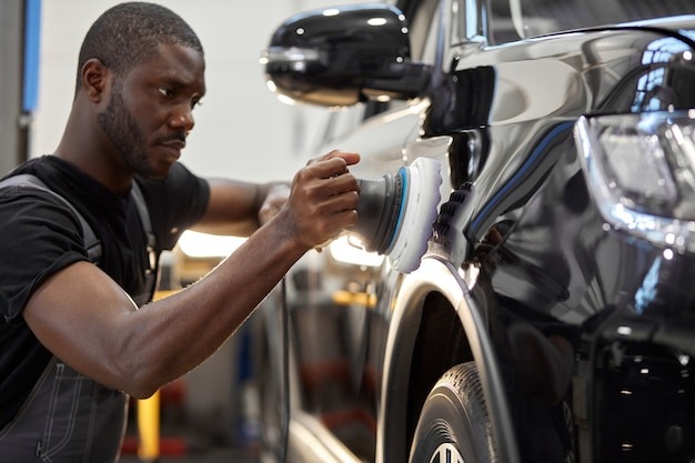 A man brushing a surface for detailing
